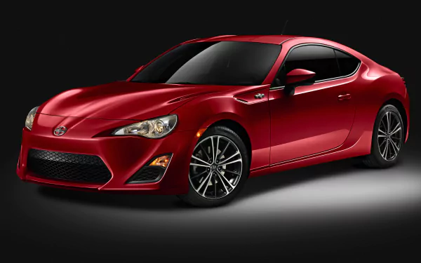 8K Ultra HD PC desktop wallpaper of a red Scion FR-S sports coupe against a dark studio backdrop.