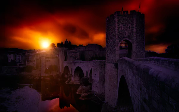 HD wallpaper of Besalú's medieval bridge in Catalonia, Spain, captured at sunset with vivid red and orange skies reflecting in the water.