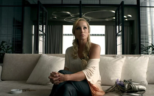 HD PC desktop wallpaper from the movie Only God Forgives, featuring a woman with braided hair seated on a white couch in a modern, dimly lit room.