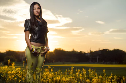 HD desktop wallpaper featuring a woman standing in a field of yellow flowers at sunset, conveying a serene mood.