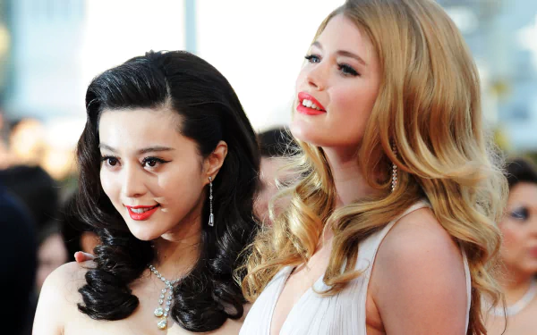 A stunning 4K Ultra HD wallpaper featuring celebrities Doutzen Kroes and Fan Bingbing, both smiling and showcasing their glamorous looks at a prestigious event.