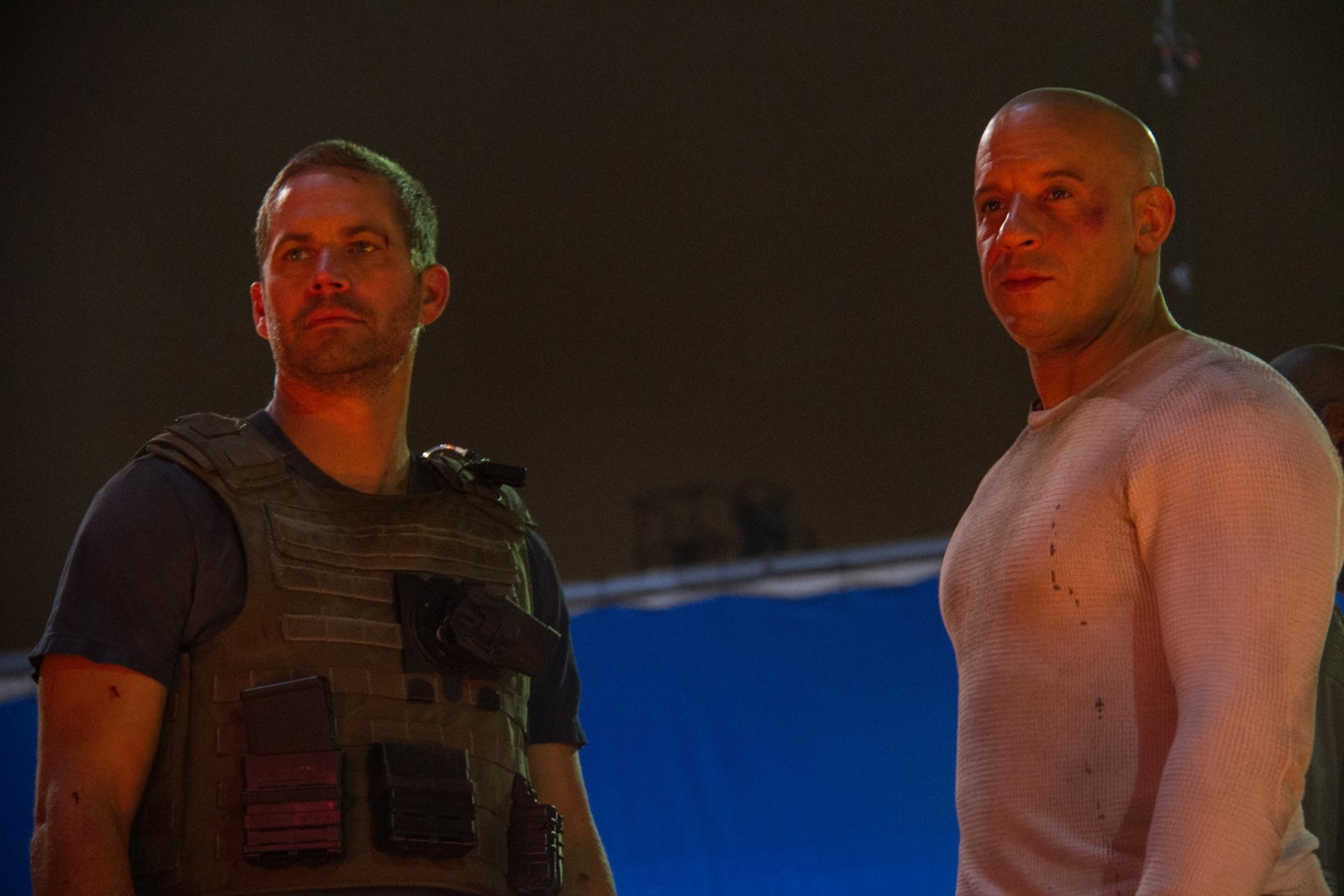 High-definition wallpaper featuring Paul Walker as Brian O'Conner and Vin Diesel as Dominic Toretto from the movie Furious 7, showcasing a dramatic behind-the-scenes moment.