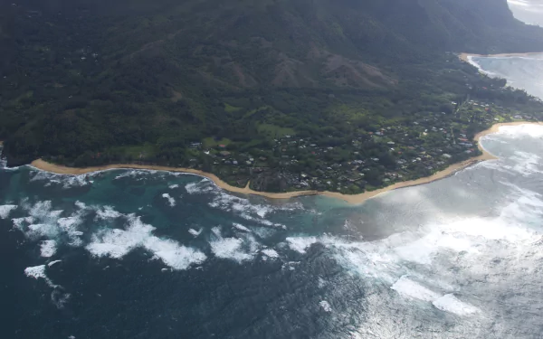 Aerial view of Kauai coastline, Hawaii: rugged island shore meeting the sea, lush inland nature — 2K Quad HD PC desktop wallpaper/background
