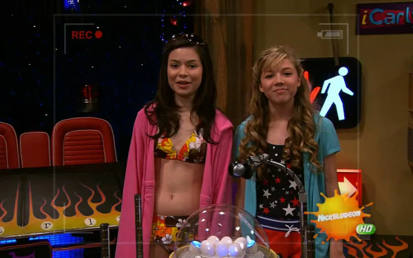 HD PC desktop wallpaper featuring characters from the TV show iCarly (2007) standing in a colorful set with gaming and show elements in the background.