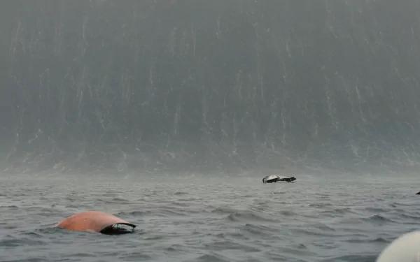 HD PC desktop wallpaper/background from the movie Interstellar: a colossal tsunami-like wall of water looms over a stormy ocean with debris and a tiny craft on the surface.