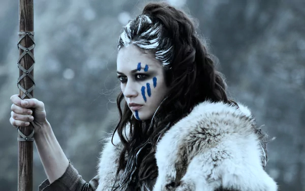 4K Ultra HD PC desktop wallpaper featuring a fierce warrior woman from the movie Centurion, adorned with blue war paint and fur clothing in a cold, misty setting.
