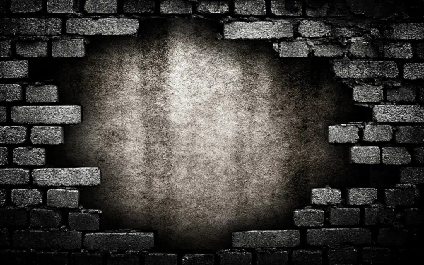 A close-up of a weathered brick wall with a textured, gray patch, creating a striking backdrop for HD PC desktops. The dark tones enhance the image's depth and character.