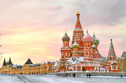 Winter view of Saint Basil's Cathedral in Moscow, Russia, showcasing its colorful domes against a soft sunset sky in 4K Ultra HD detail.