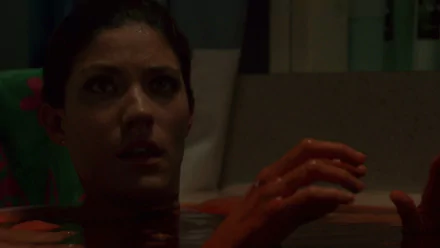 HD PC desktop wallpaper from the TV show Dexter: a dim bathroom close-up of a woman half-submerged, her hands stained red reaching above the water.