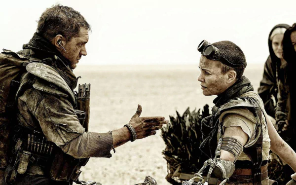 Max Rockatansky and Imperator Furiosa share a tense moment in this HD wallpaper from Mad Max: Fury Road, showcasing the movie's rugged, post-apocalyptic landscape.