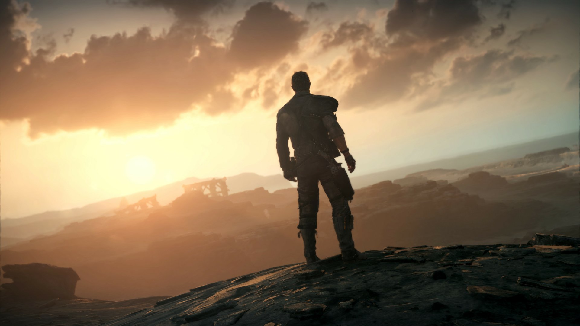 HD PC desktop wallpaper featuring a lone figure overlooking a vast, desolate landscape at sunset from the video game Mad Max.