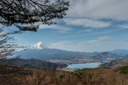 Scenic 4K view of Lake Kawaguchi and Mount Fuji in spring, Yamanashi, Japan, showcasing nature with blue skies and distant mountains.