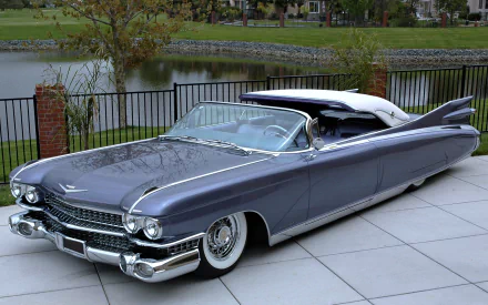 A classic Cadillac Eldorado convertible car parked by a lakeside fence, captured in 4K Ultra HD for a PC desktop wallpaper.
