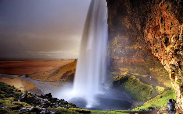 4K Ultra HD wallpaper of Iceland’s Seljalandsfoss waterfall, showcasing water cascading over a cliff with mossy rocks and a misty, dramatic natural landscape.
