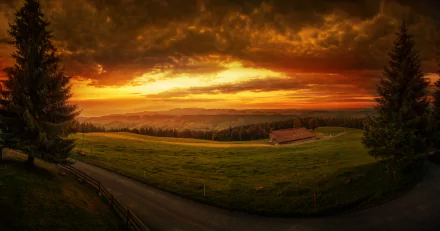 Stunning sunset over a Swiss landscape, featuring rolling hills and a tranquil road, captured in vibrant colors. This image serves as an 8K Ultra HD desktop wallpaper.