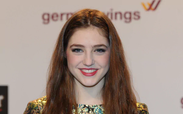 Birdy, the English singer, smiles brightly in this HD desktop wallpaper, showcasing her iconic style and infectious energy in the music scene.