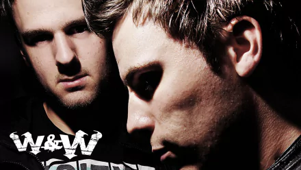 HD PC desktop wallpaper featuring close-up portraits of the DJs W&W, highlighting their intense expressions in a dark, moody music-themed setting.