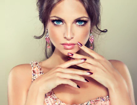 A high-definition desktop wallpaper of a woman model showcasing elegant earrings. Her face is prominently featured with a poised expression, creating a striking and sophisticated background.