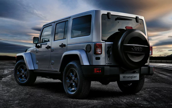 A Jeep Wrangler parked on a rugged landscape, showcasing its 4x4 capabilities under a dramatic sky. This 4K Ultra HD image serves as an eye-catching desktop wallpaper.