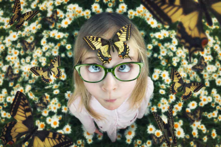 A blonde child with blue eyes and green glasses surrounded by butterflies, standing amid white flowers in a whimsical, manipulated HD desktop wallpaper.