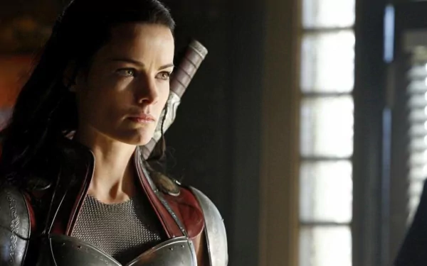 HD desktop wallpaper featuring a character from the TV show Agents of S.H.I.E.L.D. in tactical gear, illuminated by soft window light in a dim room.