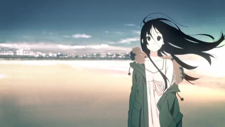 HD anime desktop wallpaper featuring Mio Akiyama from K-ON! standing on a beach with wind blowing through her long black hair and city lights in the background.