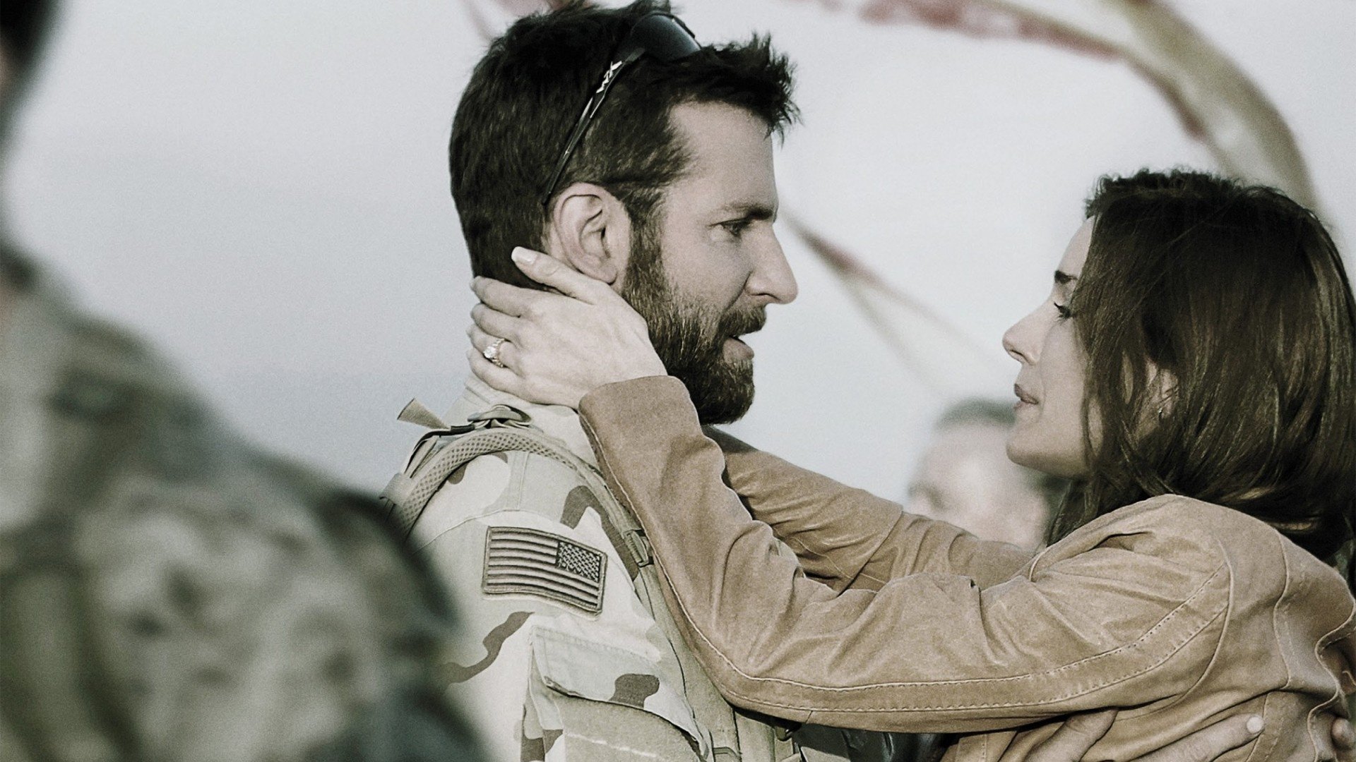A poignant moment between two characters from the movie *American Sniper*, captured in an HD desktop wallpaper, showcasing their emotional connection.