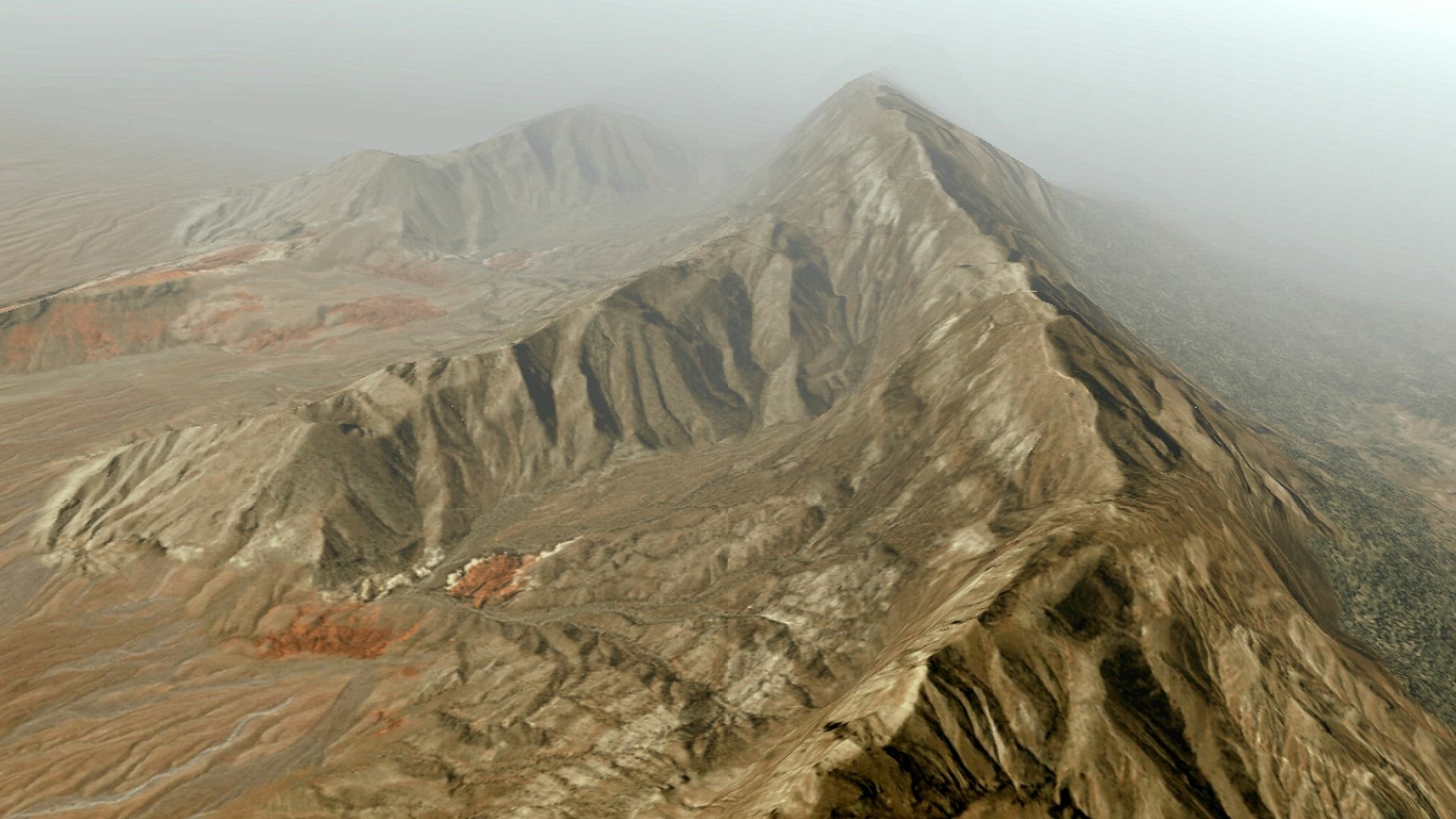 Aerial view of a rugged mountain ridgeline and misty valleys — HD PC desktop wallpaper from the video game Ace Combat Zero: The Belkan War.