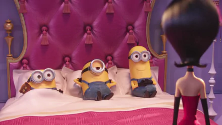 HD desktop wallpaper featuring Scarlet Overkill facing Kevin, Stuart, and Bob (Minions) who are sitting and lying on a bed, with a cute, pink-themed movie setting in the background.