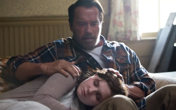 HD PC desktop wallpaper from the movie Maggie (2015): a weary, protective man sits on a couch with a young woman asleep across his lap, soft daylight filtering through a curtained window.