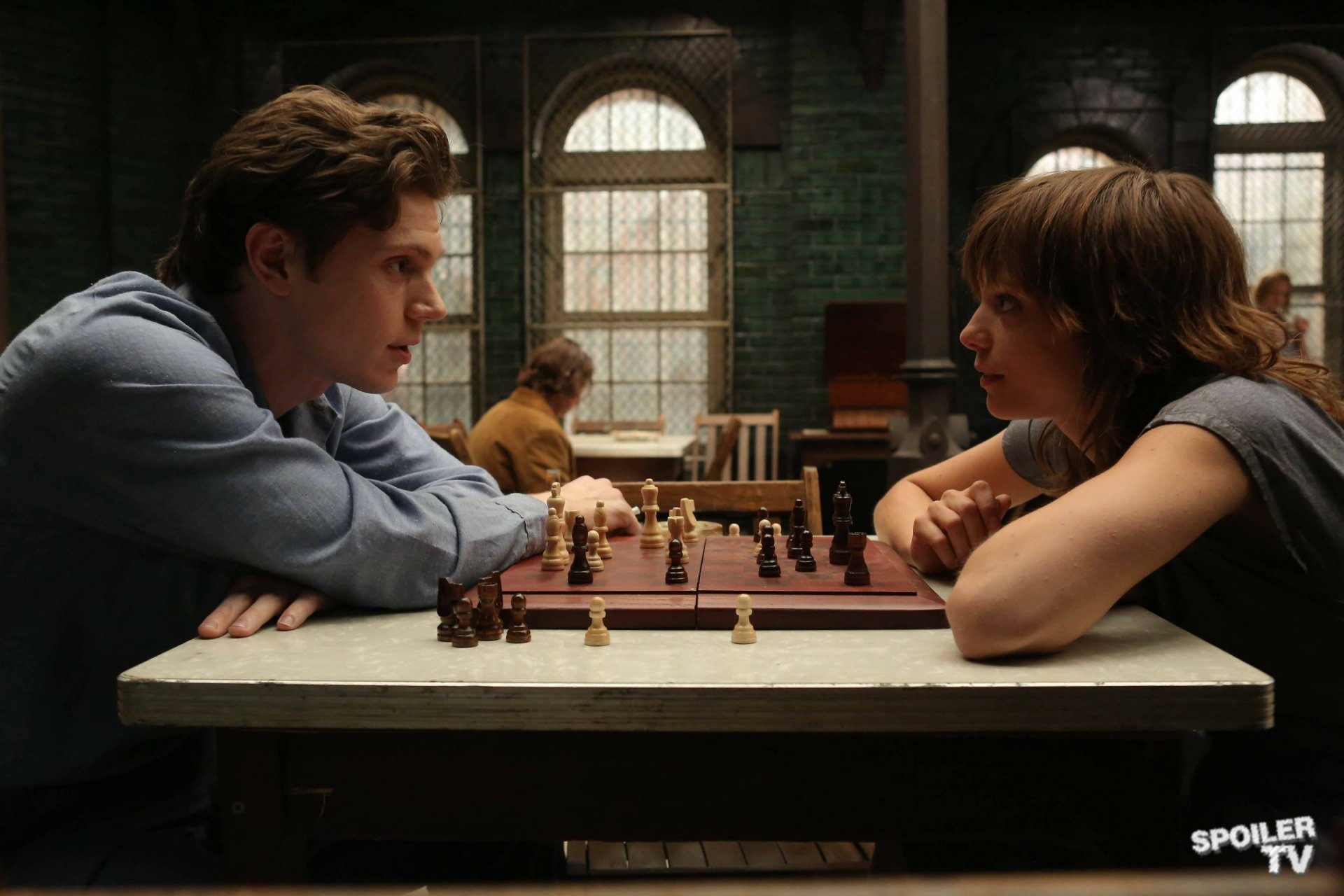 HD PC desktop wallpaper featuring Evan Peters in a scene from the TV show American Horror Story, focused on an intense chess match.