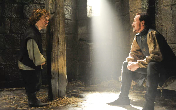 HD desktop wallpaper featuring Peter Dinklage as Tyrion Lannister and Jerome Flynn as Bronn in a dimly lit scene from the TV show Game of Thrones.