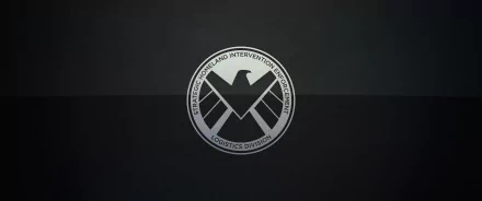 A sleek HD desktop wallpaper featuring the S.H.I.E.L.D. logo from the comic universe, set against a dark background for a minimalist yet striking visual appeal.