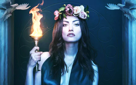 Phoebe Tonkin shines in this striking HD wallpaper from the TV show The Originals, holding a torch and wearing a floral crown against a dark, mystical backdrop.