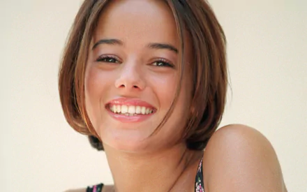 HD PC desktop wallpaper featuring a close-up of smiling singer Alizée, capturing her warm expression and natural beauty in a music-themed image.