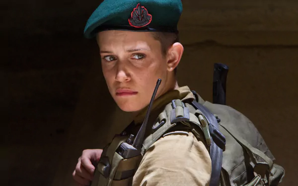 Daniella Kertesz in military gear from the movie World War Z, captured in a dramatic HD PC desktop wallpaper background.