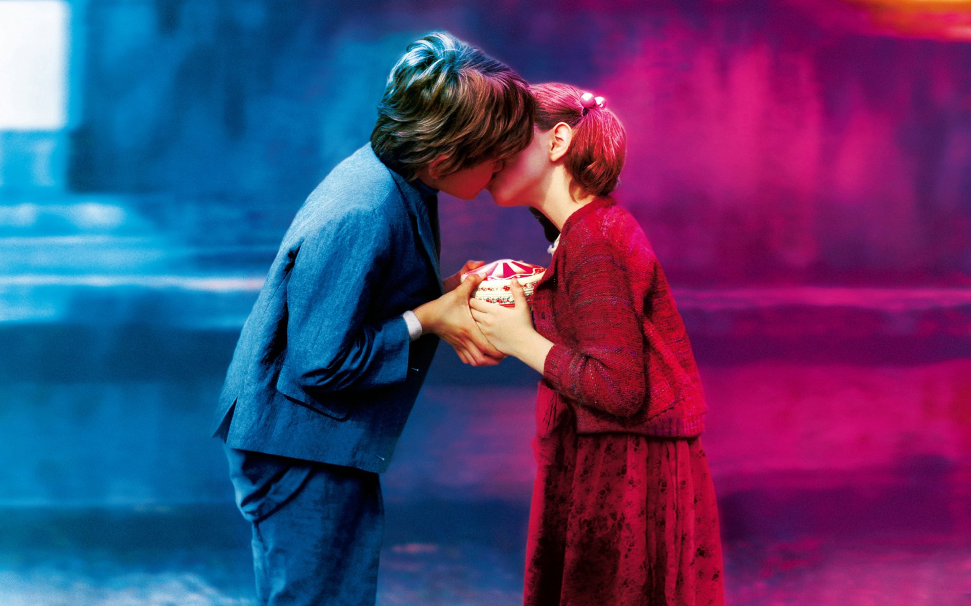 A vibrant HD wallpaper capturing a tender moment of two figures sharing a kiss, embodying love and intimacy in a beautifully composed photograph.