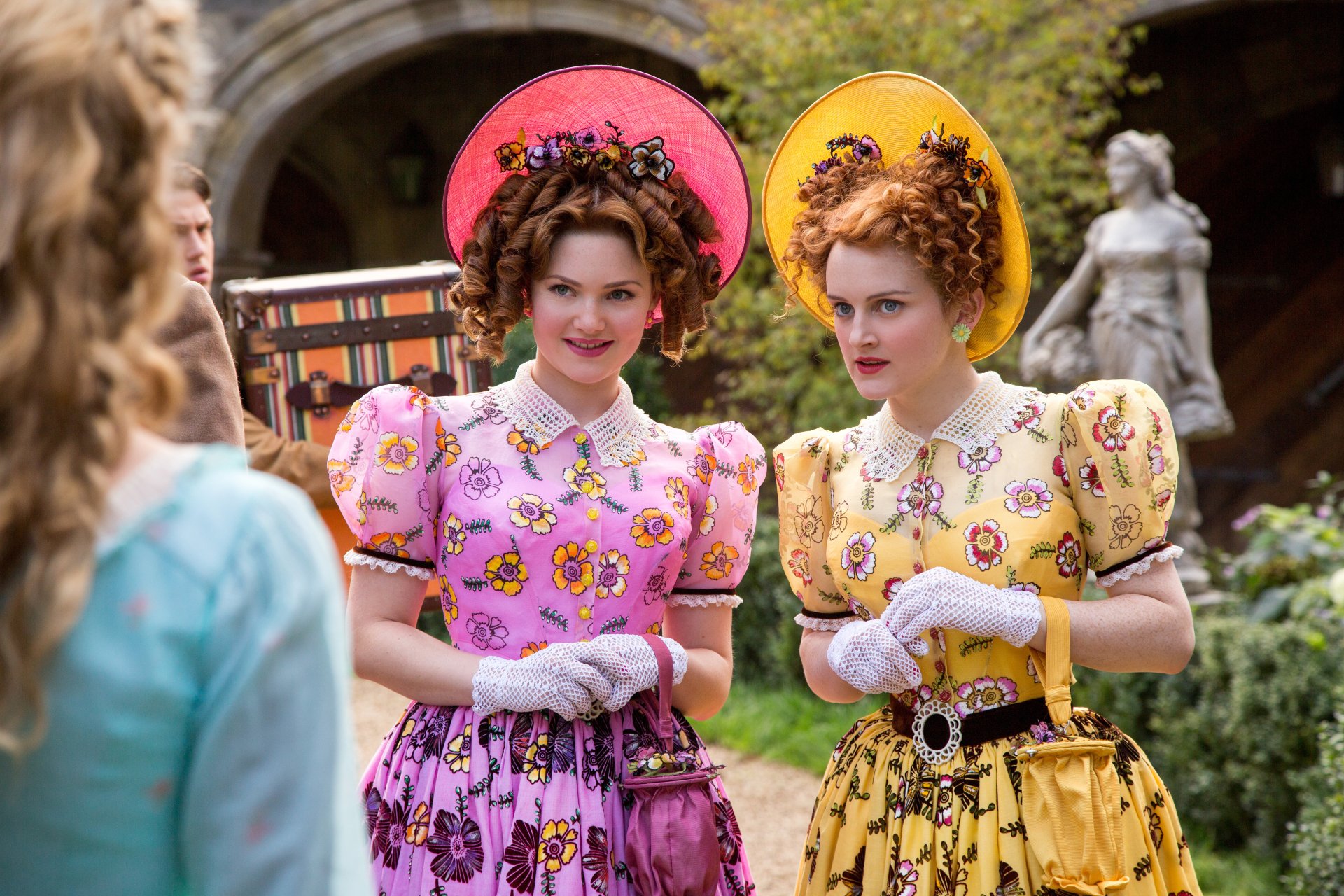 5K Ultra HD PC desktop wallpaper/background from Cinderella (2015) showing two ornate stepsisters in pink and yellow dresses confronting Cinderella in a sunlit garden.