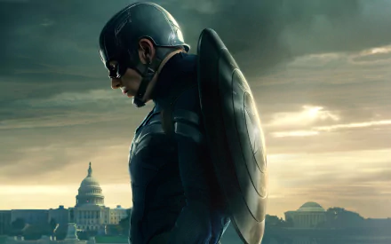 HD wallpaper featuring Captain America, portrayed by Chris Evans, in a dramatic pose against a backdrop of clouds and the Capitol building from the movie Captain America: The Winter Soldier.