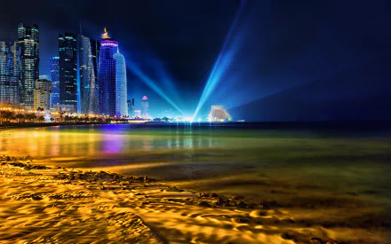 HD desktop wallpaper of Doha at night, featuring illuminated skyscrapers and vibrant light beams reflecting on the water. The shoreline glows with city lights, creating a stunning man-made landscape.