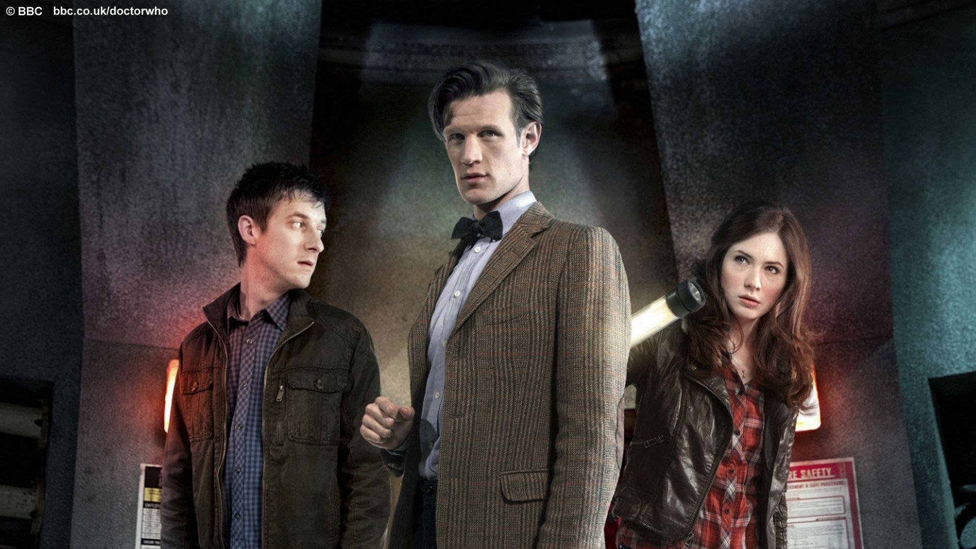 HD desktop wallpaper featuring Doctor Who (2005) characters Amy Pond, played by Karen Gillan, and the Eleventh Doctor, played by Matt Smith, in a dramatic pose.