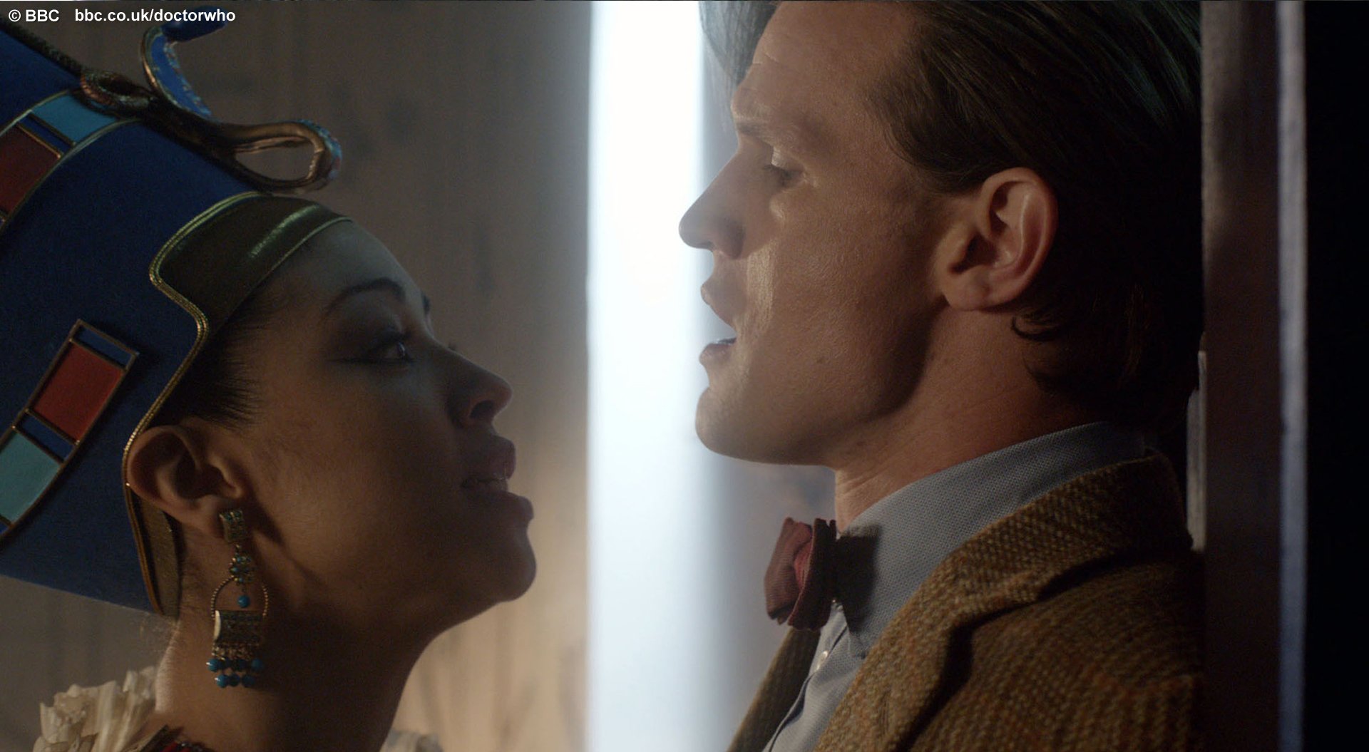 HD desktop wallpaper featuring a close-up scene from Doctor Who (2005) with the Eleventh Doctor facing a regal woman in elaborate headdress and makeup.