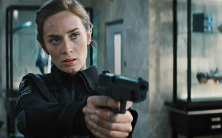 Emily Blunt in a gripping scene from the movie Edge of Tomorrow, wielding a gun with determination, captured in high-definition for a striking desktop wallpaper.