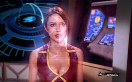HD PC desktop wallpaper: holographic female crew officer from TV show Andromeda on a starship bridge with glowing consoles and a circular starchart
