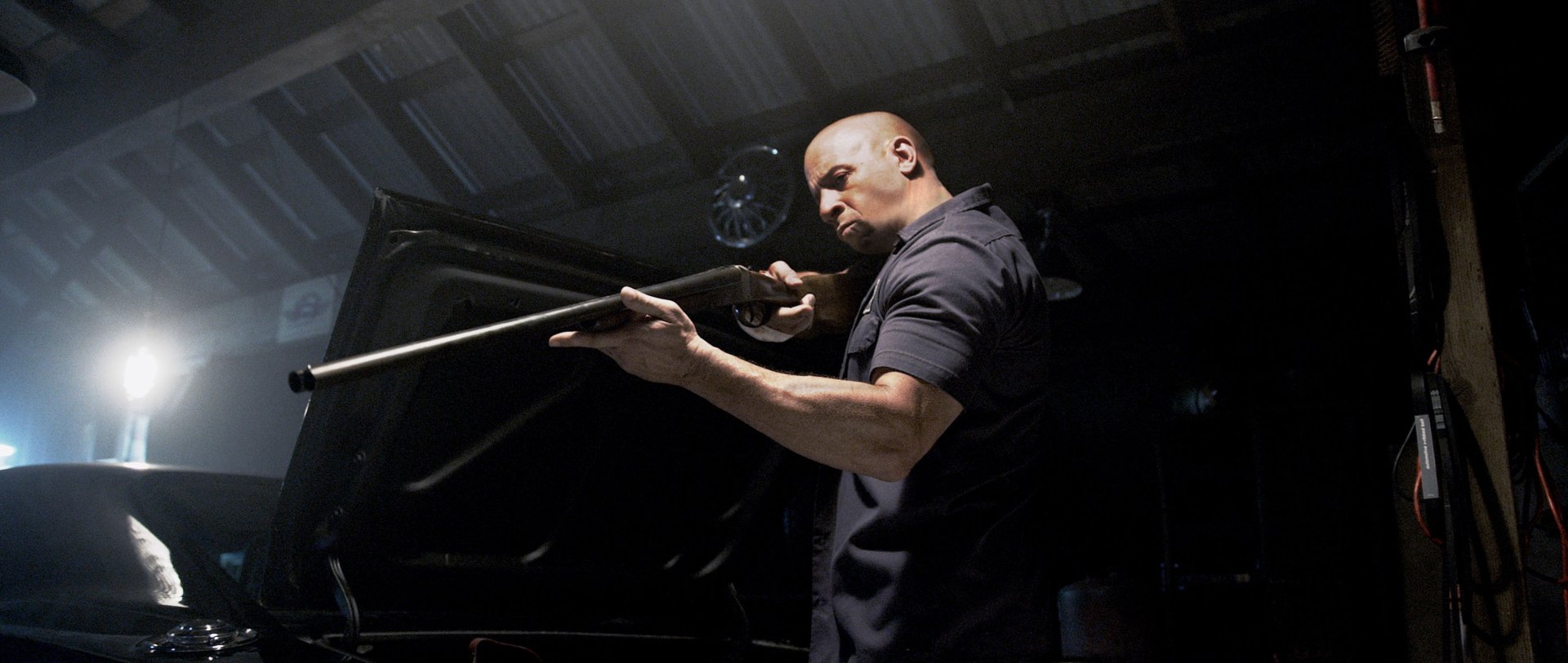 Vin Diesel as Dominic Toretto in a dramatic scene from Furious 7. The image is a high-definition desktop wallpaper, capturing intense action and atmosphere.