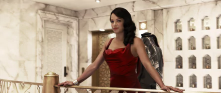 HD wallpaper and background featuring Letty Ortiz, portrayed by Michelle Rodriguez, in a scene from the movie Furious 7. She is dressed elegantly in a red gown, standing against a luxurious interior background.