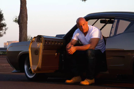 Vin Diesel as Dominic Toretto in Furious 7, crouching by a car with an open door, featured in a HD desktop wallpaper and background.
