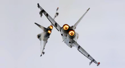 Two Eurofighter Typhoon jets with afterburners engaged, captured in flight against a clear sky, featured as an HD military desktop wallpaper background.
