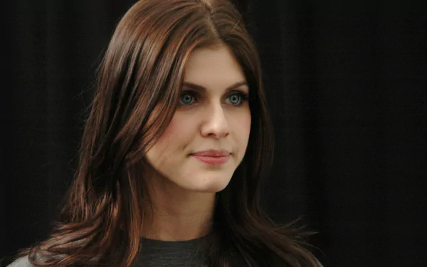 A high-definition desktop wallpaper featuring actress Alexandra Daddario, showcasing her natural beauty and captivating presence against a dark background.