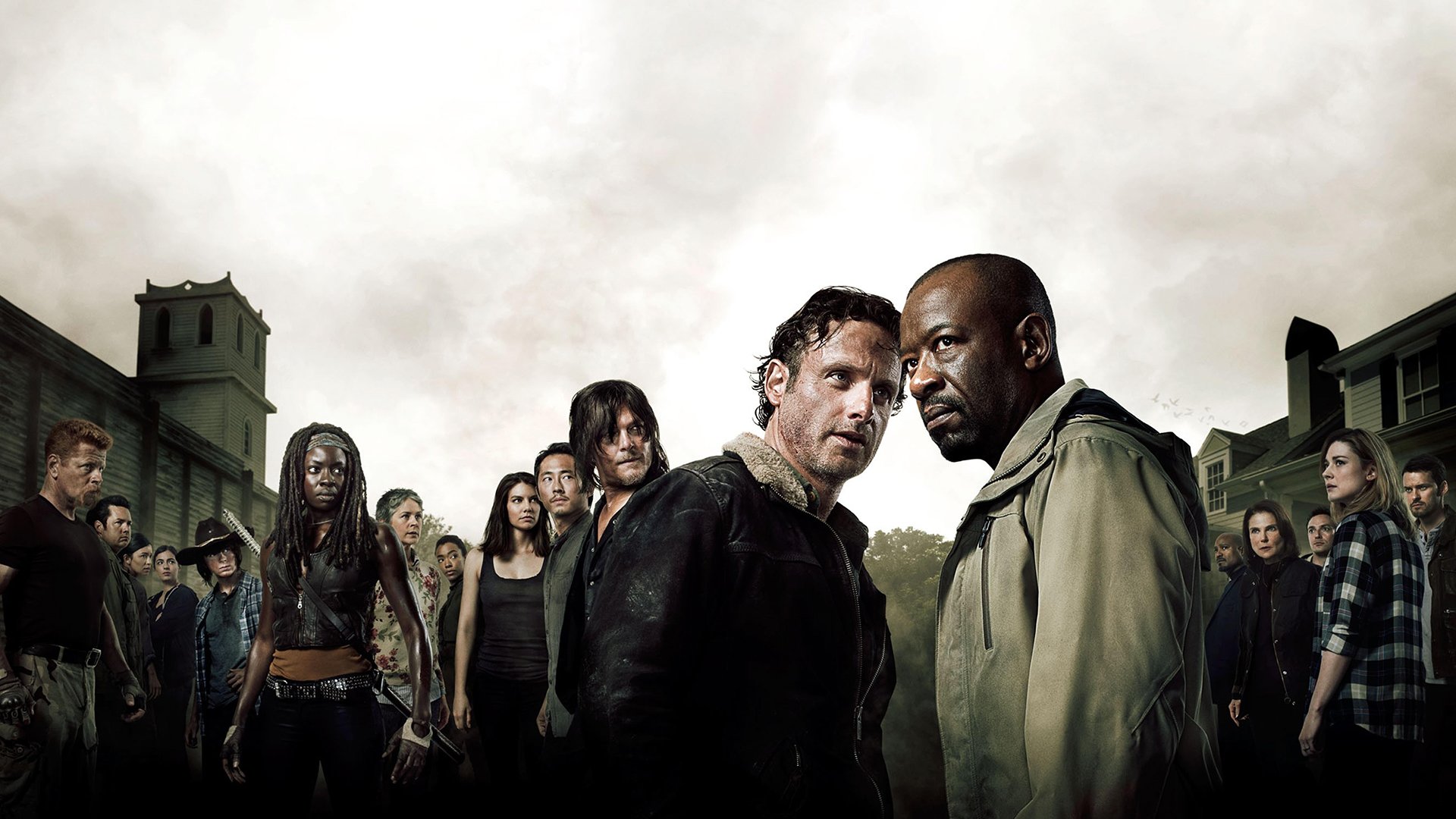 HD desktop wallpaper featuring main characters from the TV show The Walking Dead standing together against a gloomy, overcast sky with a town backdrop.